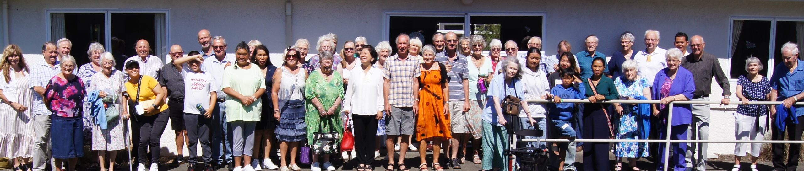 Photo of Stoke Baptist congregation in front of the church on a sunny day